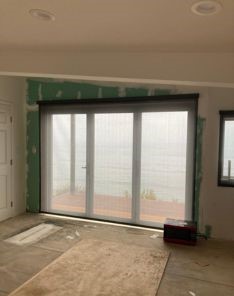 Stylish automatic window treatments in a bright Laguna Beach living area.