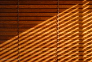 Faux wood blinds adding warmth to a living room window.